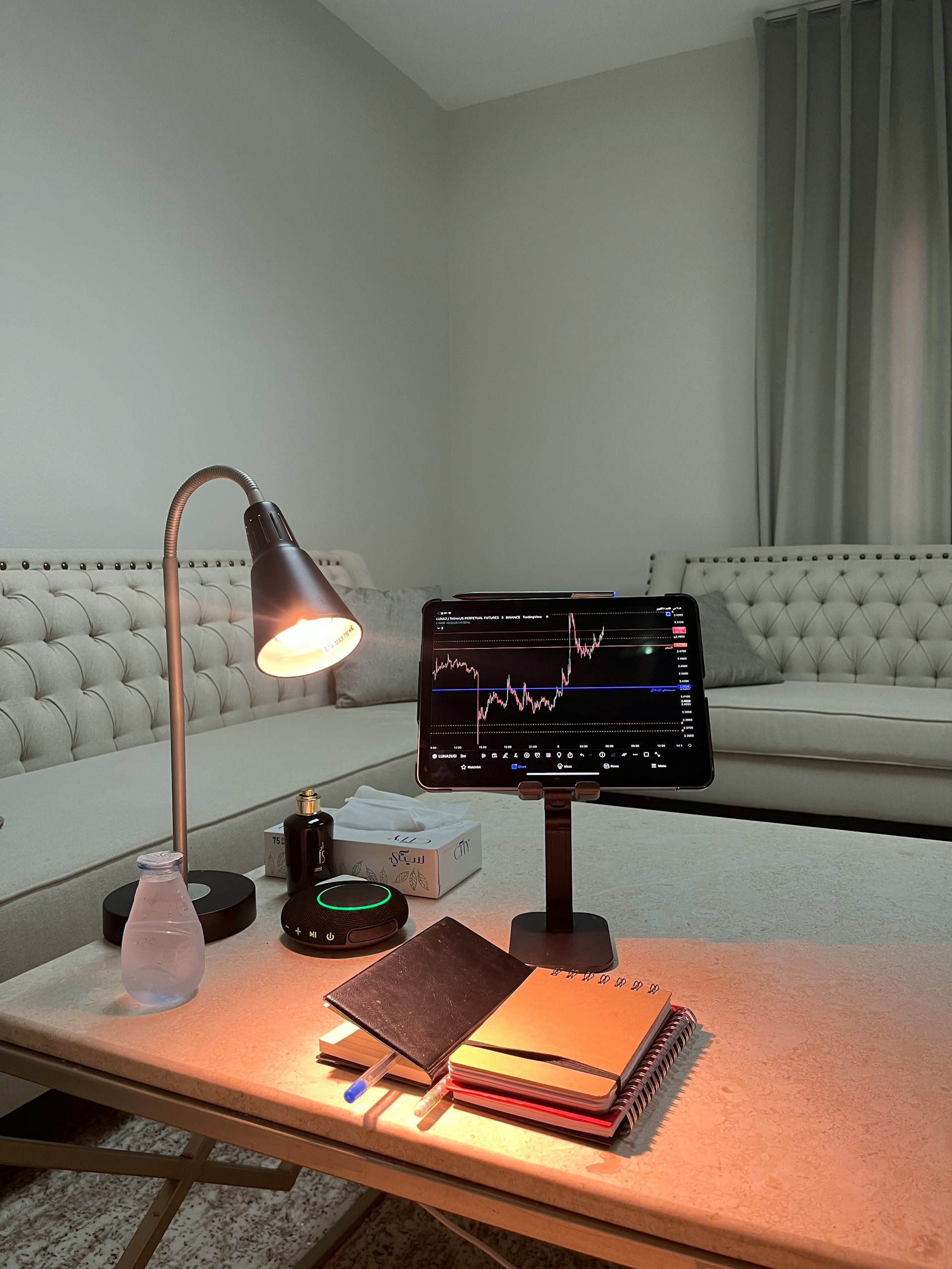 a table with a lamp and books on it
